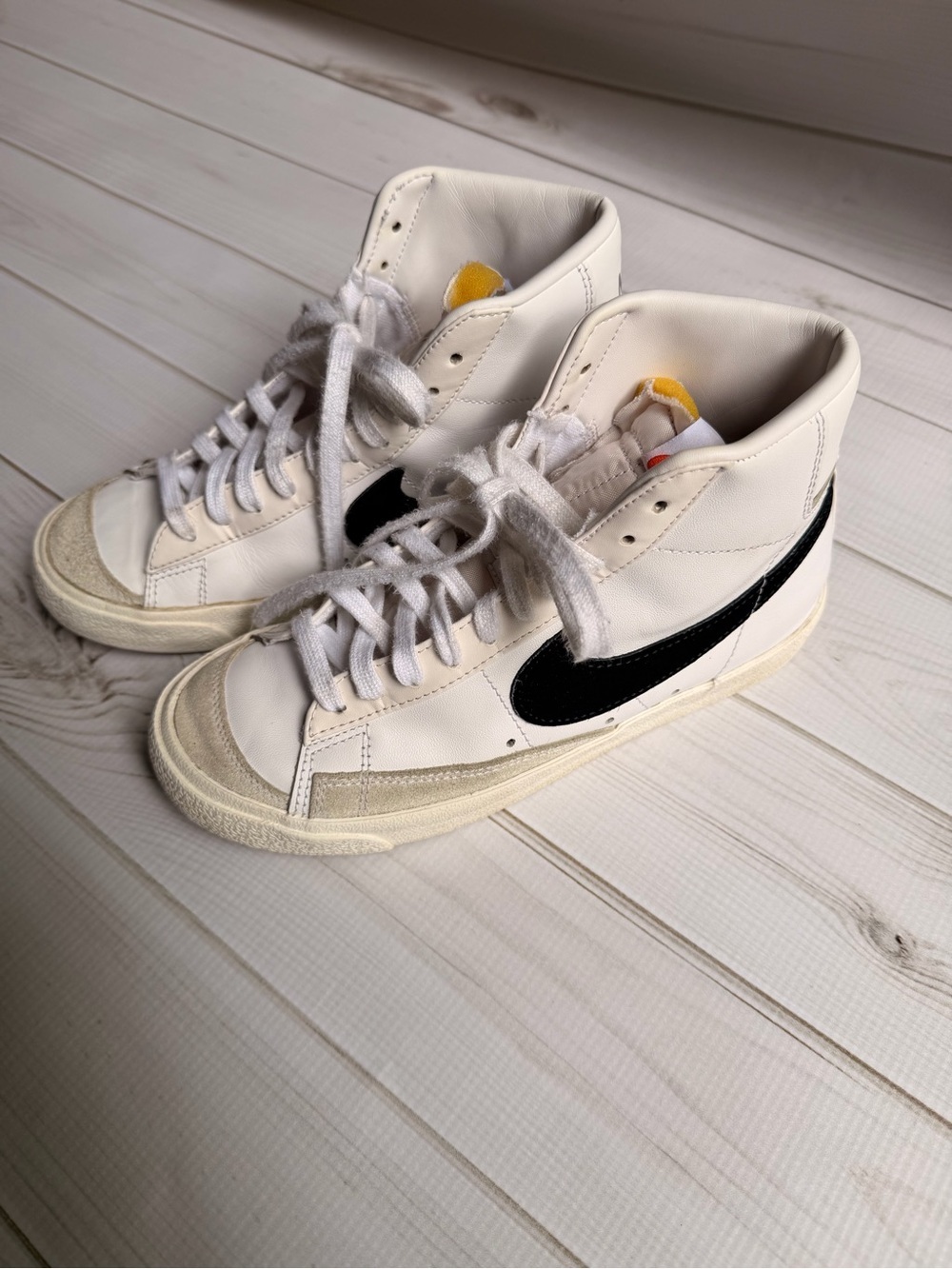 Nike White High-Top Sneakers with Black Swoosh